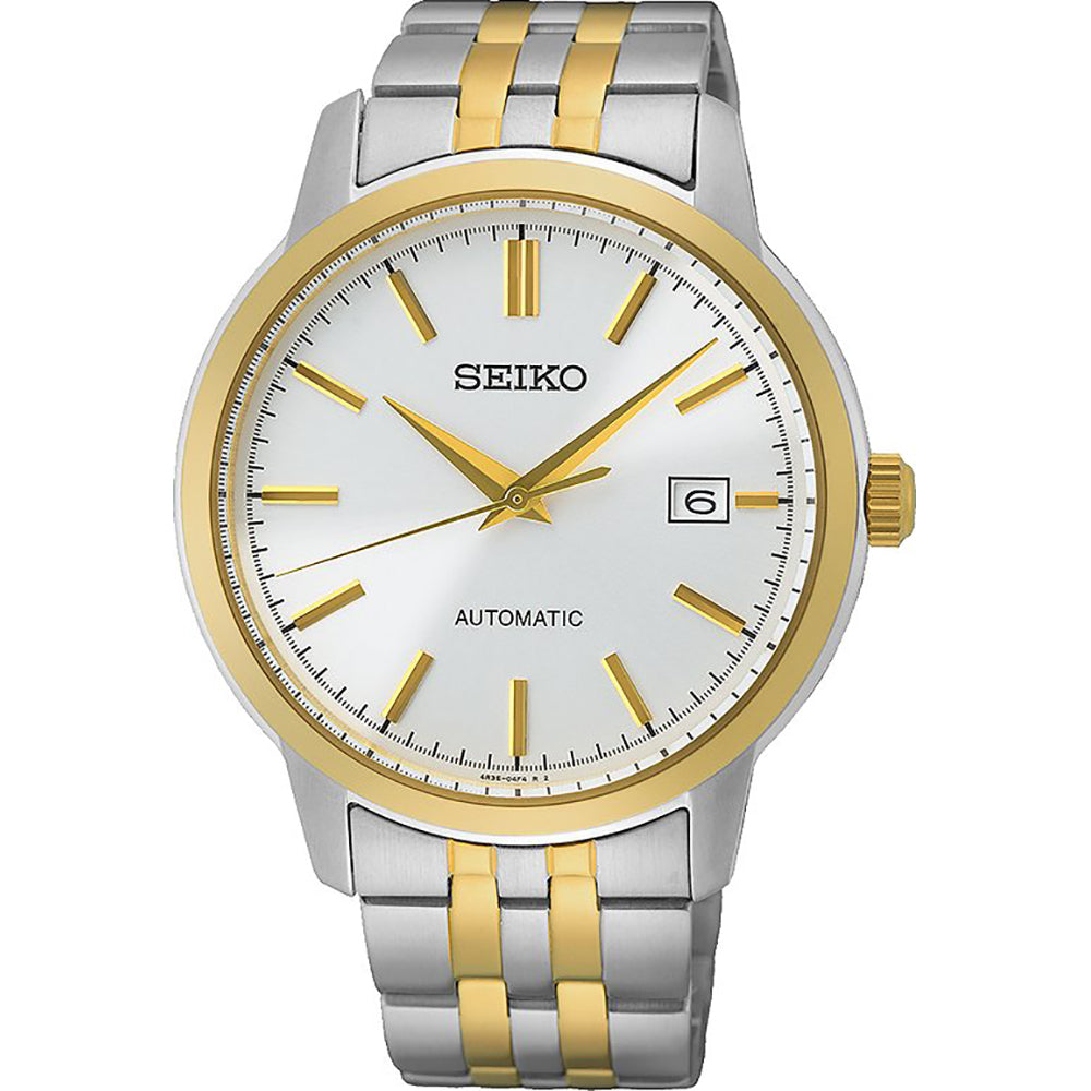 Montre automatique pour homme avec boîtier argenté, bracelet en acier inoxydable, cadran blanc et détails dorés.