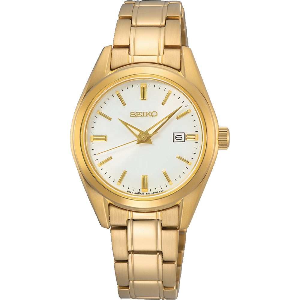 Montre dorée pour femme avec un cadran blanc et un bracelet en métal.