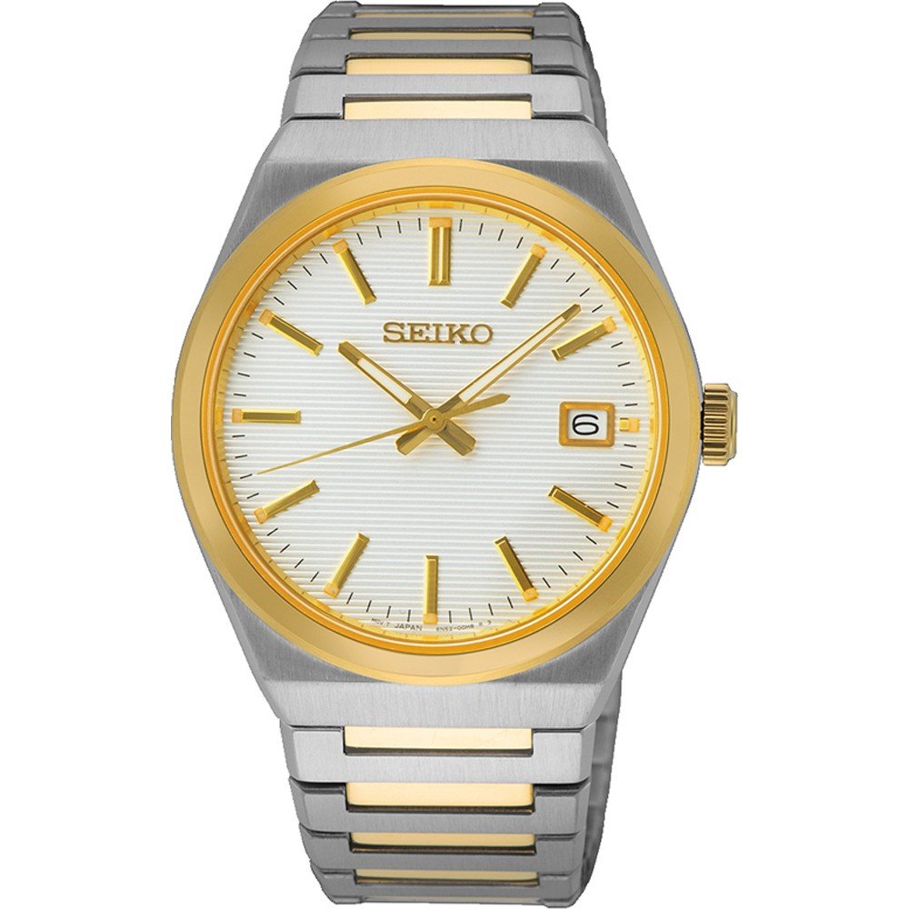 De Seiko heren horloge SUR558P1 heeft een zilverkleurige en goudkleurige metalen band, witte wijzerplaat met structuur, goudkleurige lunette, goudkleurige uurmarkeringen en wijzers, datumvenster op 3 uur en wordt aangedreven door een quartz uurwerk voor een betrouwbare tijdmeting.