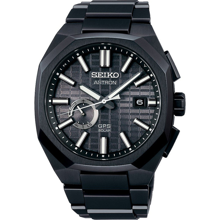 Een close-up van het Seiko Astron heren horloge SSJ015J1 polshorloge toont zijn GPS-zonnetechnologie en zonne-energie. Het heeft een getextureerde zwarte wijzerplaat met zilveren uurmarkeringen, drie wijzers, een datumvenster op 3 uur en wordt gecompleteerd door een strakke titanium horlogeband voor verfijning.
