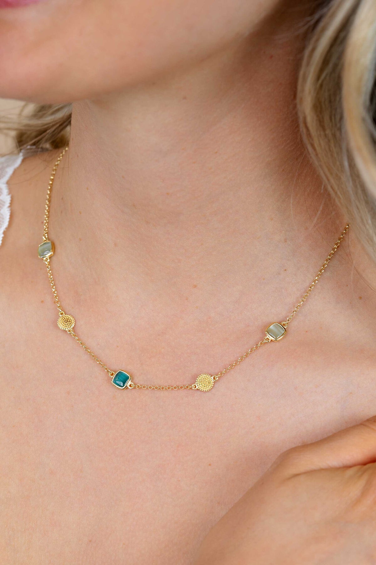 Gouden vergulde zilveren ketting van 45 cm met drie vierkante kleurstenen in zachte groentinten.