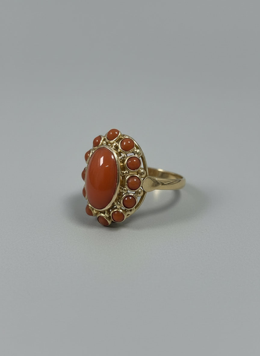 Bague vintage en or 14 carats ornée d'un cabochon de corail rouge et de petites perles de corail.