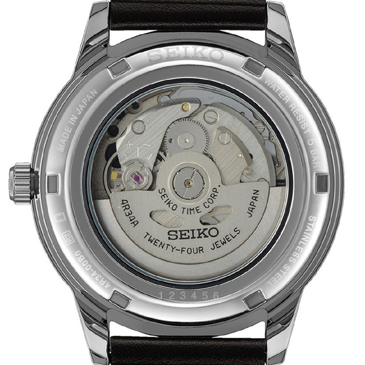 De afbeelding toont de achterkant van een Seiko Presage heren horloge SSK013J1, met de transparante achterkant die het ingewikkelde automatische uurwerk onthult. Dit horloge heeft een roestvrijstalen kast en een zwarte leren band.
