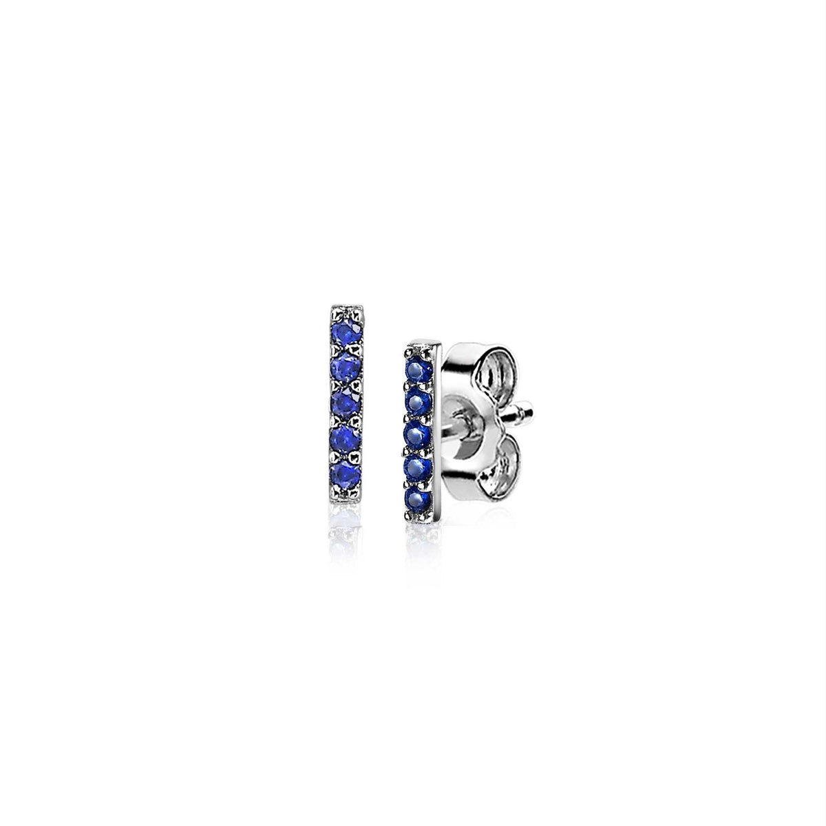 Boucles d'oreilles en argent avec des pierres bleues disposées en ligne.