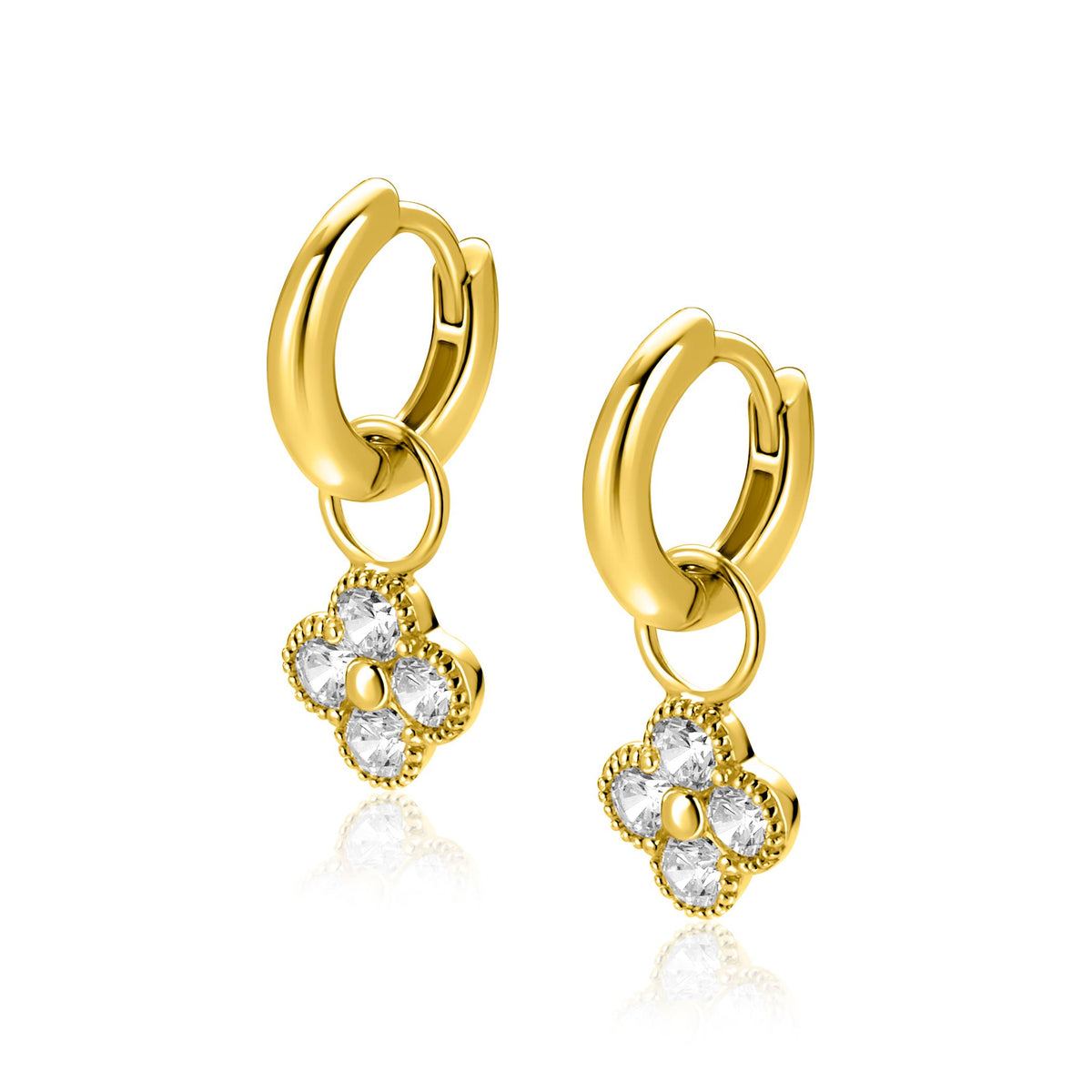 Boucles d'oreilles en or avec un pendentif en forme de fleur orné de pierres brillantes.