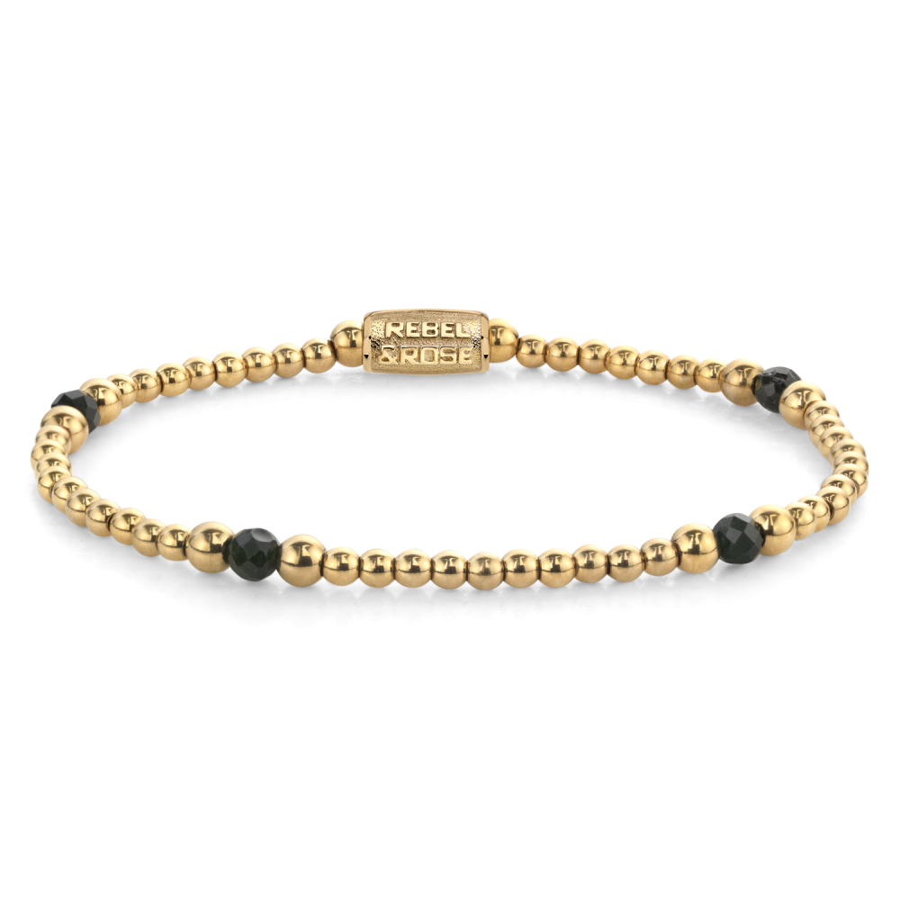 Bracelet doré avec perles noires et dorées, design simple et moderne.