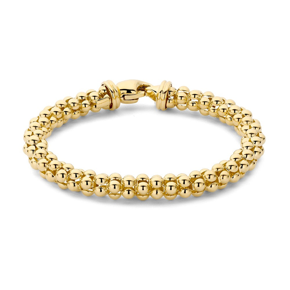 Bracelet en or jaune avec des perles rondes et un fermoir en métal.