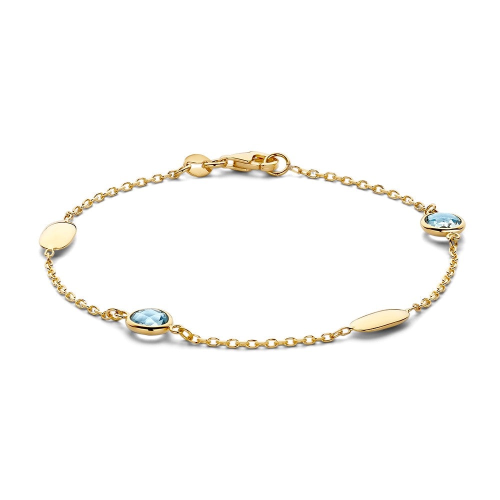 Bracelet en or jaune avec des pierres précieuses bleues et des éléments ovales.