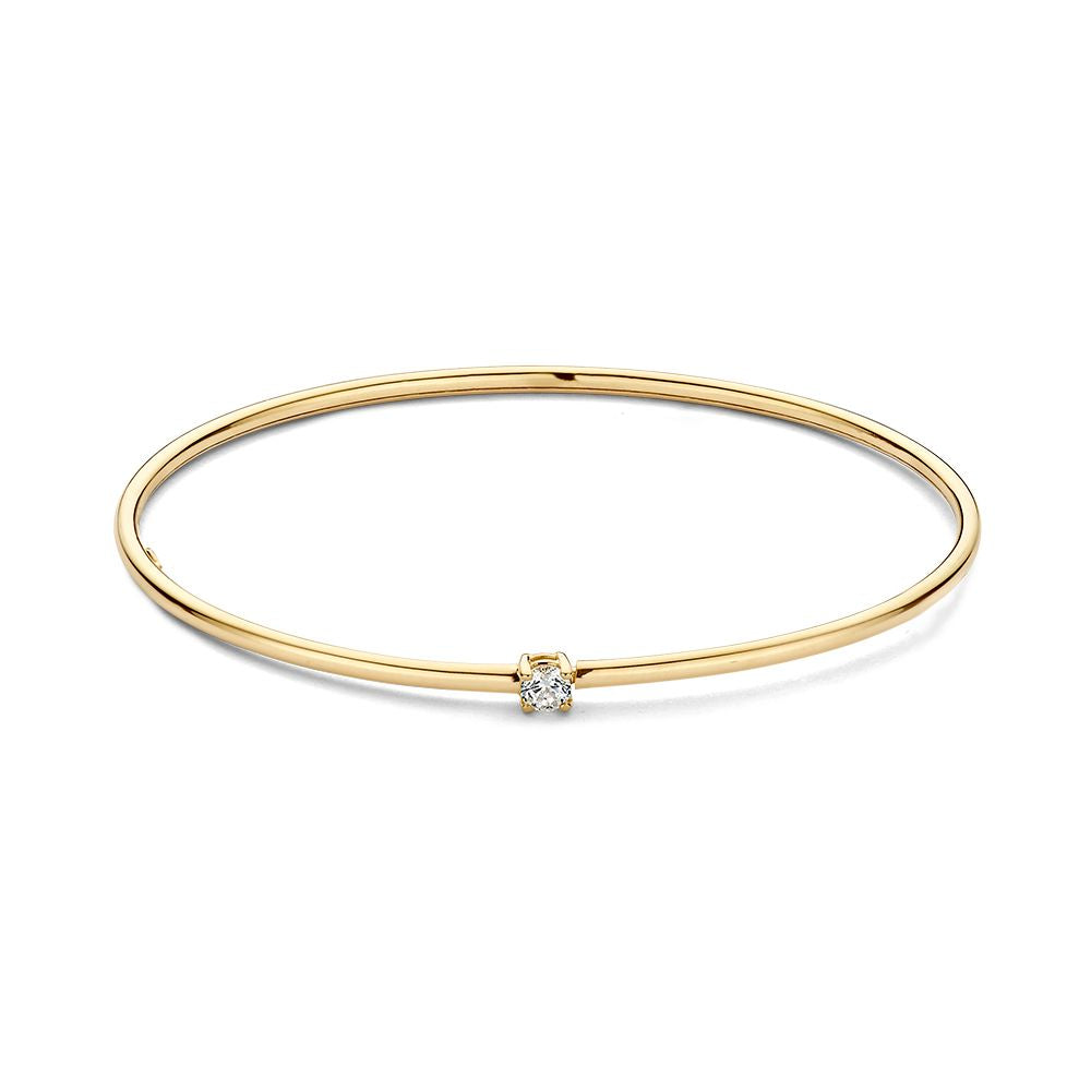 Bracelet jonc en or jaune 14 carats avec un zircon.