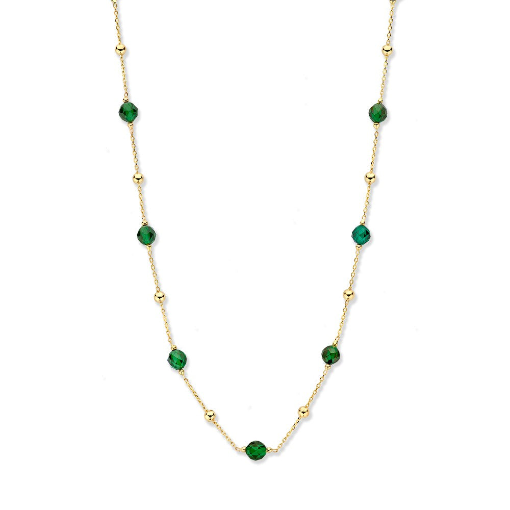 Collier en or jaune avec des billes dorées et des zirconias vertes.