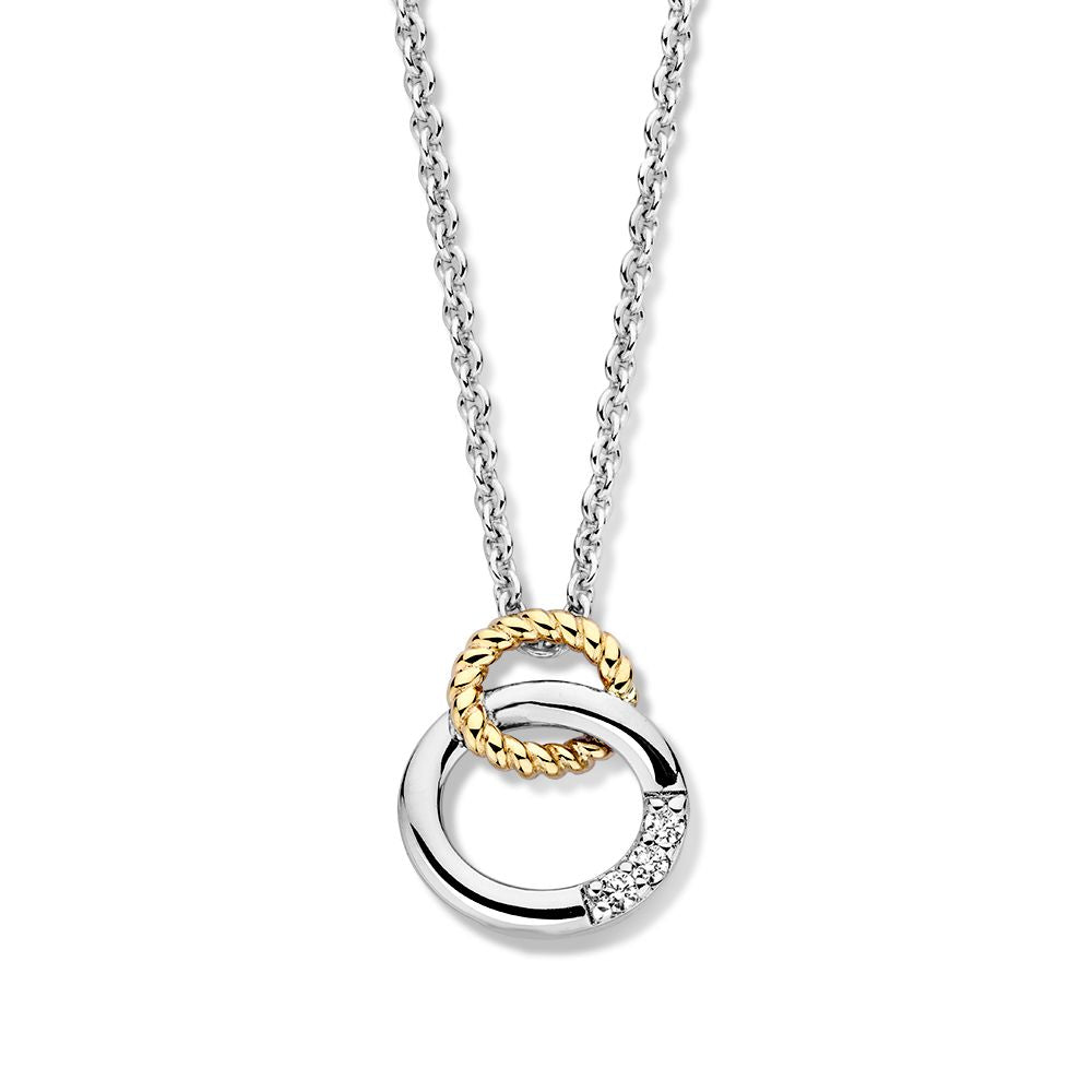 Collier en argent avec pendentif doré et trois zirkonia, design en entrelacs.
