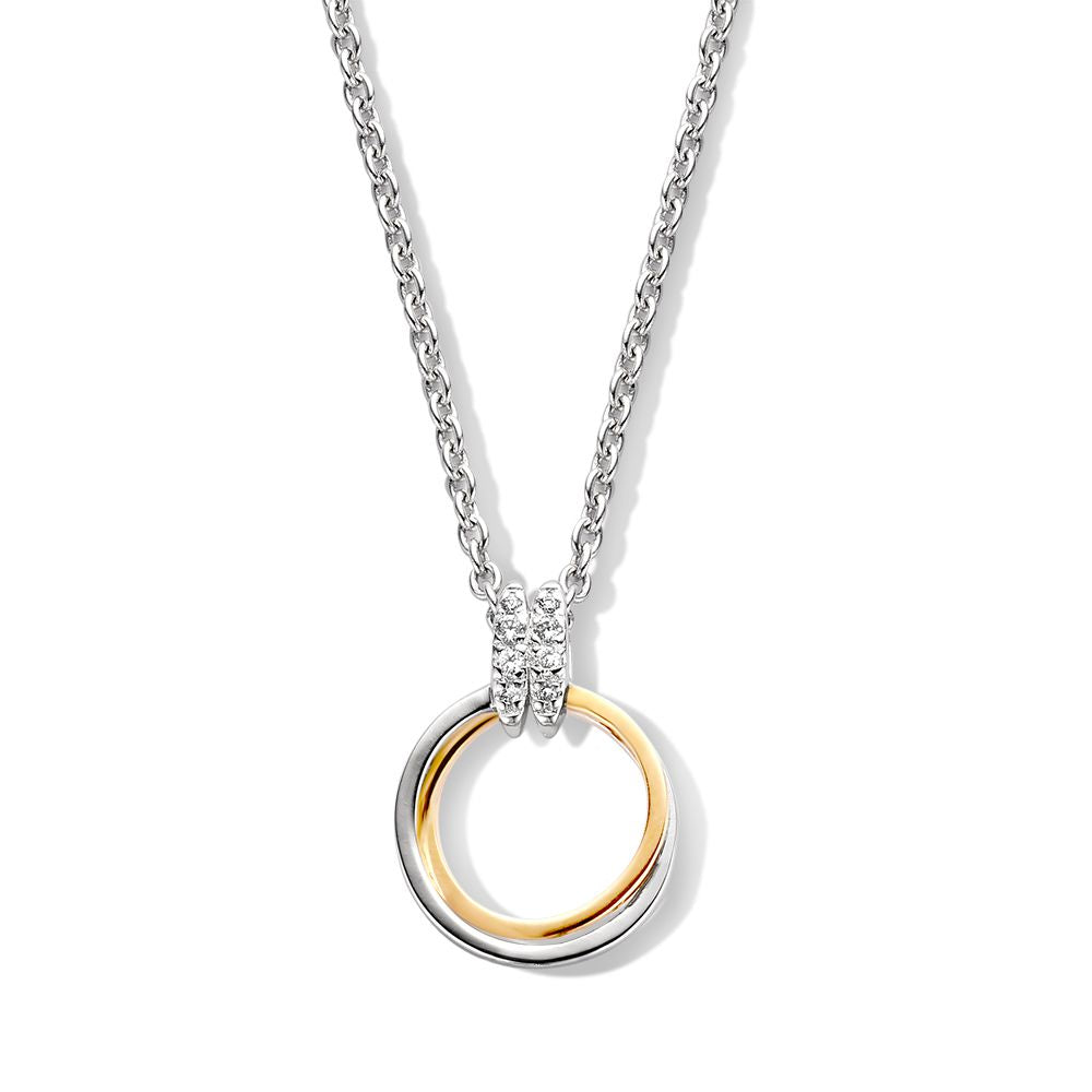 Pendentif argenté avec un anneau doré et des zircones blanches, diamètre de 20 mm.