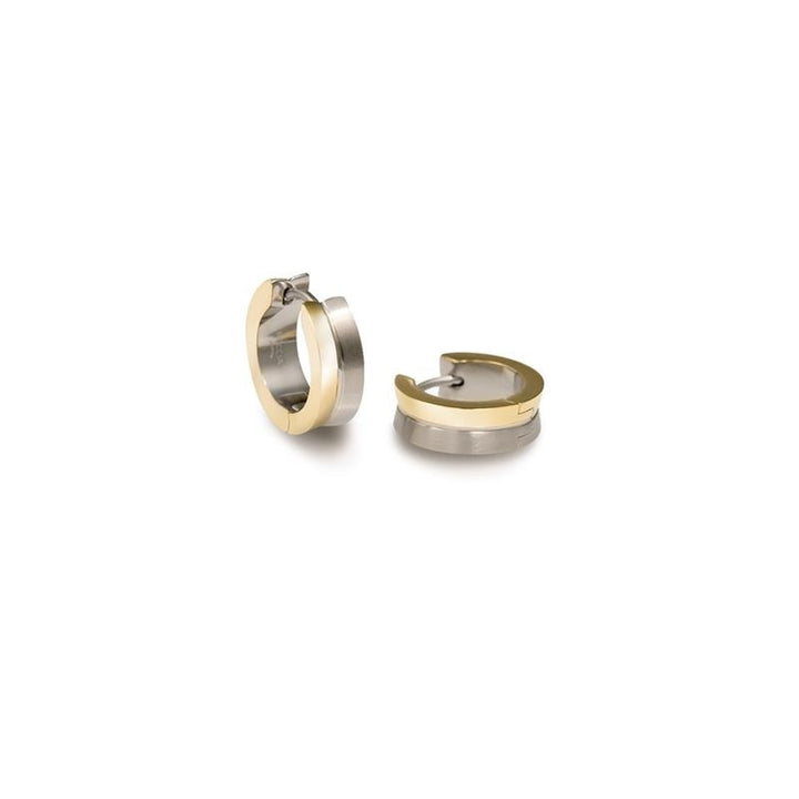 De Boccia Titanium Oorringen Bicolor 0511-01 zijn kleine tweekleurige oorbellen in zilver en goud. Eén oorbel staat rechtop, terwijl de andere plat ligt om het gespdetail te laten zien. Merk: Boccia.
