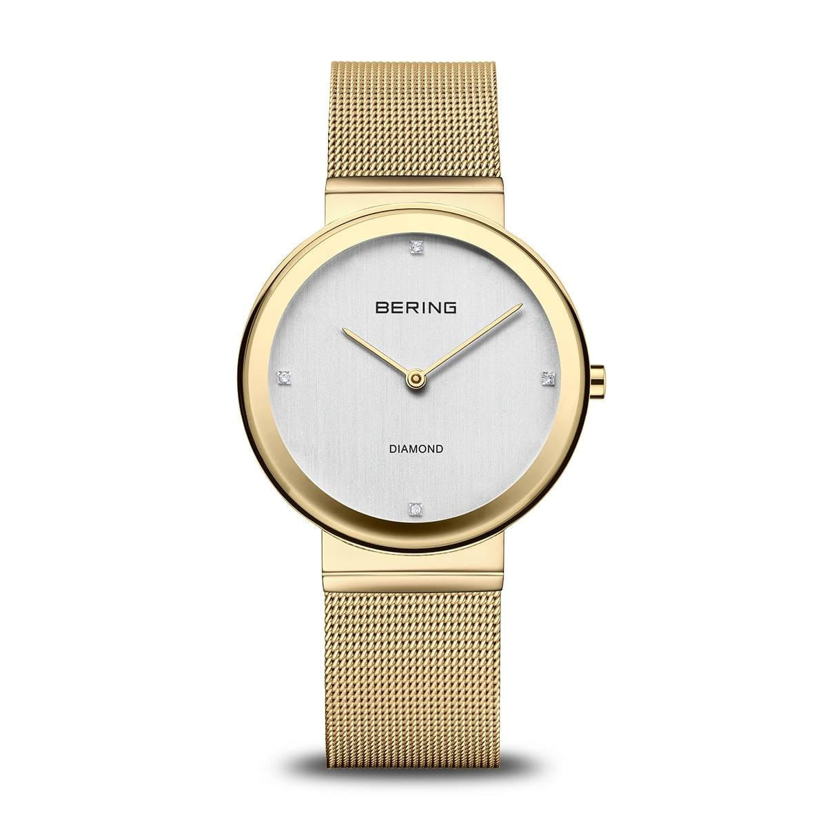 Montre femme Bering avec boîtier doré, cadran argenté et bracelet en maille dorée.