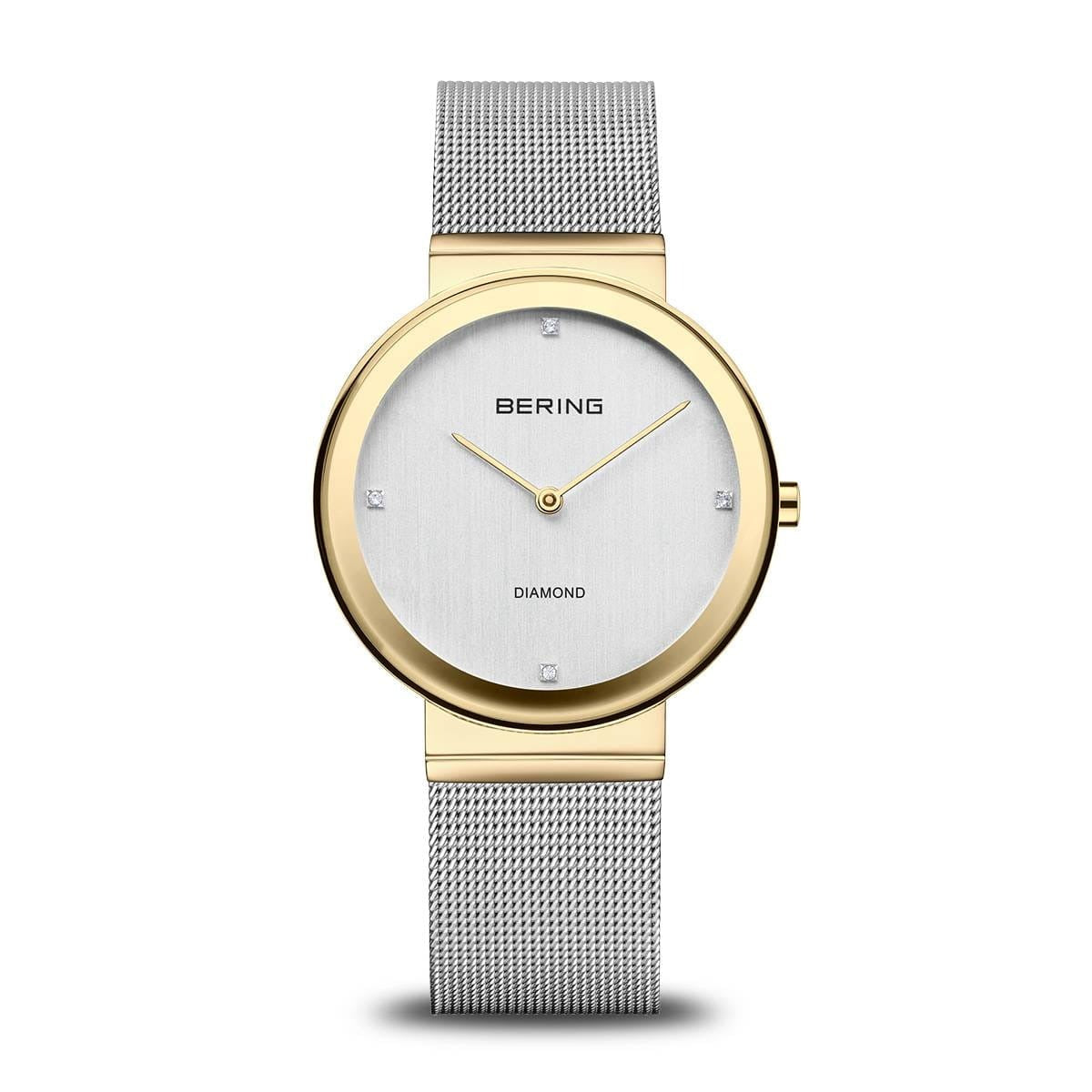 Montre femme Bering avec boîtier doré, cadran argenté et bracelet en maille métallique argentée.