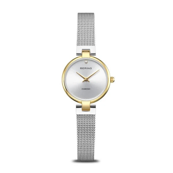 Montre femme Bering Classic, dorée avec un bracelet milanais argenté et un cadran argenté.