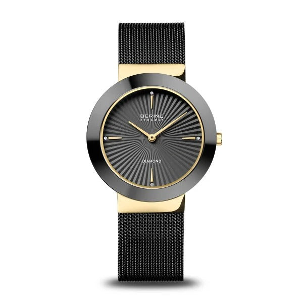 Montre pour femme Bering en céramique, dorée avec des détails en diamant et un cadran noir.