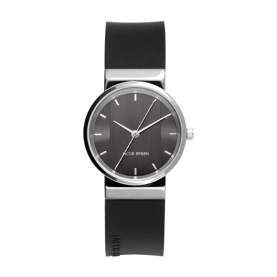 Montre avec un boîtier argenté, cadran gris et bracelet en silicone noir.