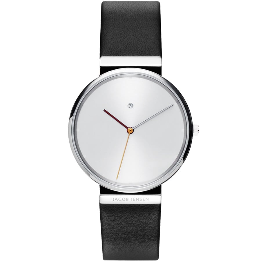Montre minimaliste avec cadran argenté, bracelet en cuir noir et aiguilles colorées.