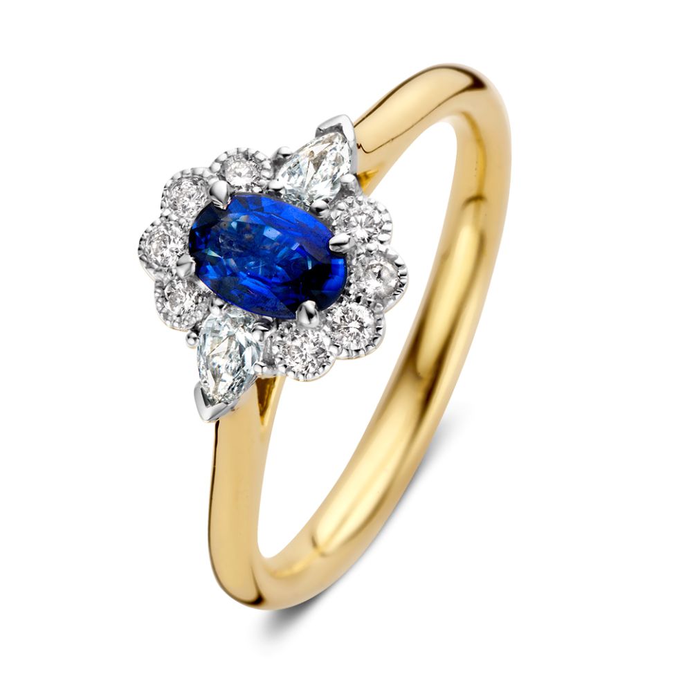 Bague en or 14 carats avec saphir bleu ovale et halo de diamants.