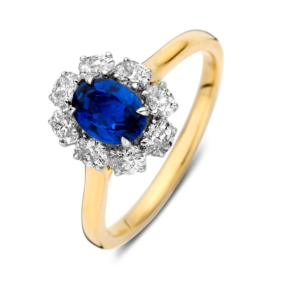 Bague bicolore en or avec un saphir ovale et des diamants brillants.