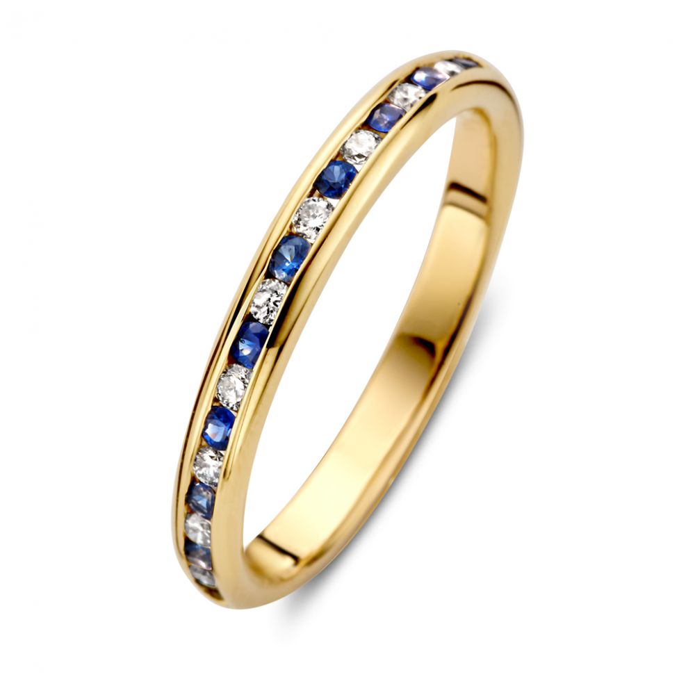 Bague en or jaune raffinée avec diamants et saphirs bleus en sertissage rail.