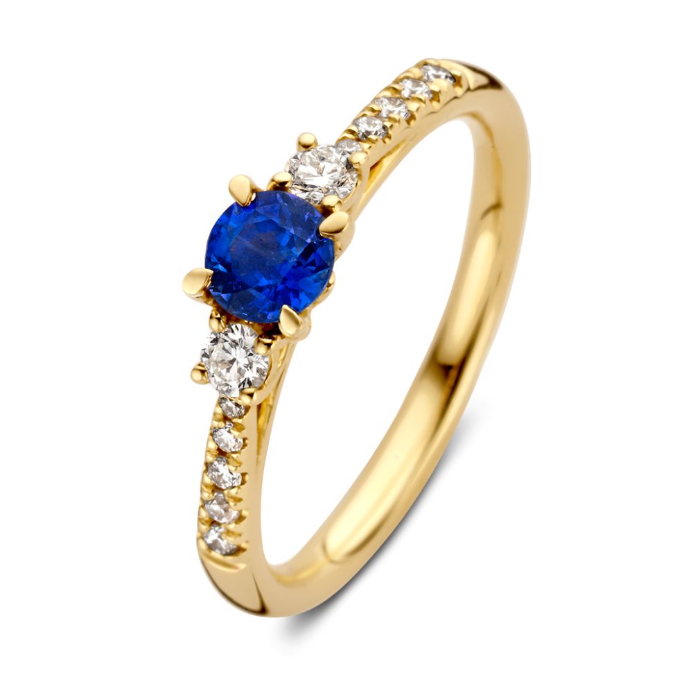 Bague en or jaune élégante avec un saphir bleu et des diamants.