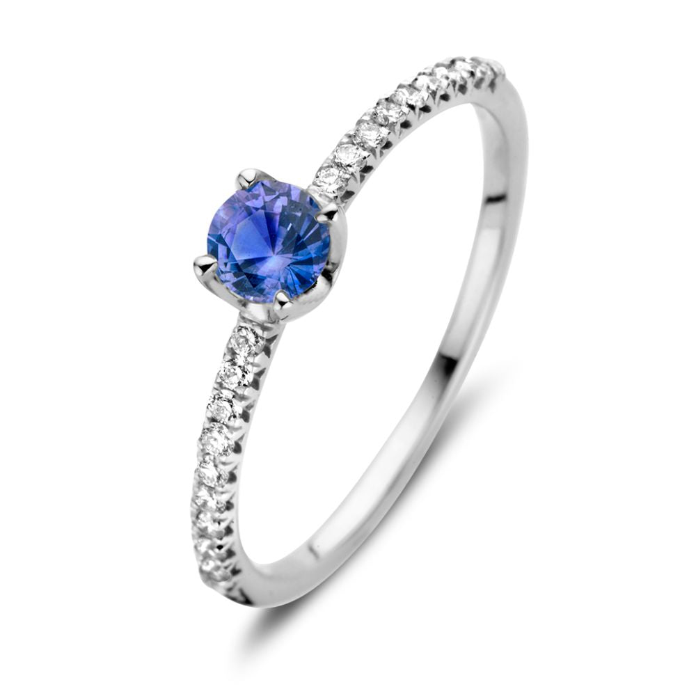 Bague en or blanc 18 carats avec saphir bleu et diamants de 0,15 ct.