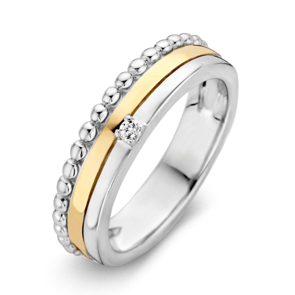 Bague en argent et or avec zirkonia, ornée de perles et d'une bande lisse.