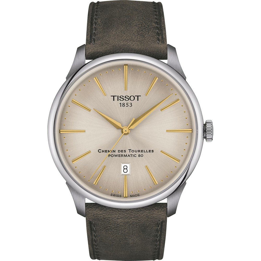 Montre Tissot Chemin des Tourelles avec cadran argenté, aiguilles dorées et bracelet en cuir marron.