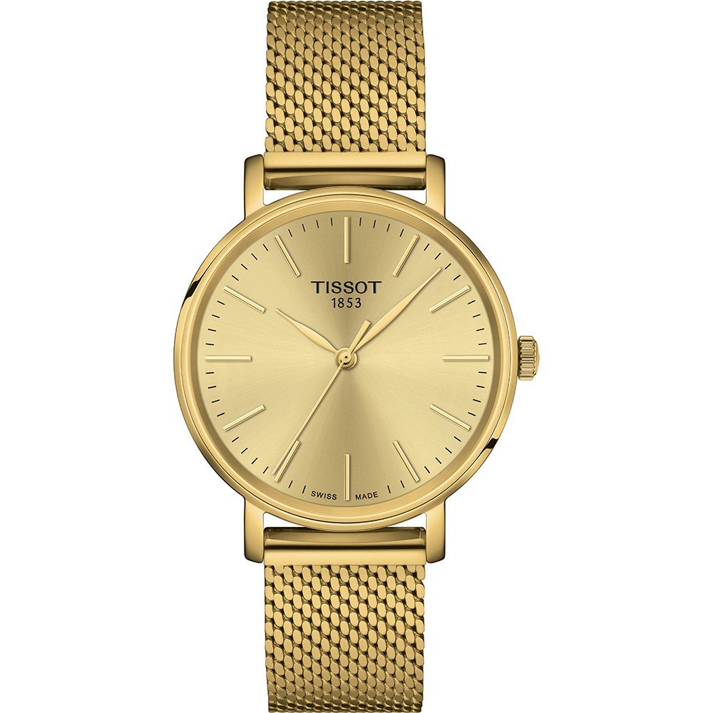 Montre Tissot dorée avec un cadran minimaliste et un bracelet en maille.