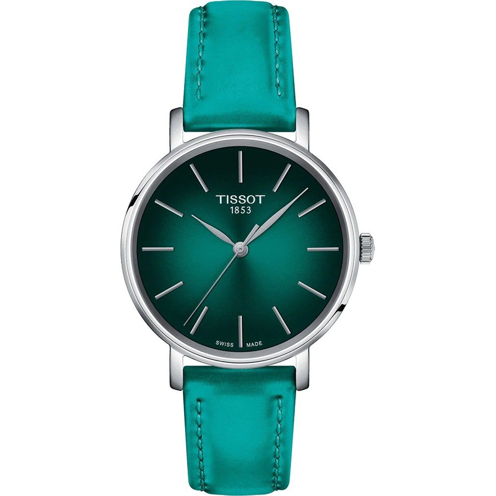 Montre Tissot avec un cadran vert émeraude, boîtier en acier et bracelet en cuir turquoise.