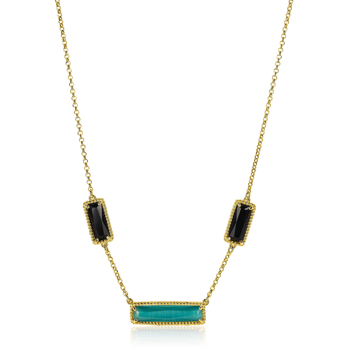 Collier doré avec trois pendentifs, dont un rectangle turquoise et deux ovales noirs.