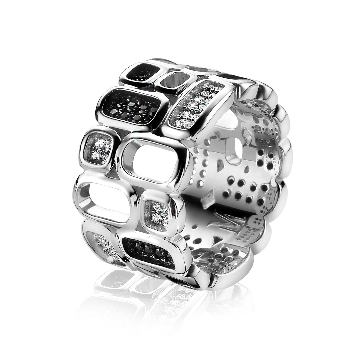 Bague en argent avec motifs géométriques et pierres noires et blanches.