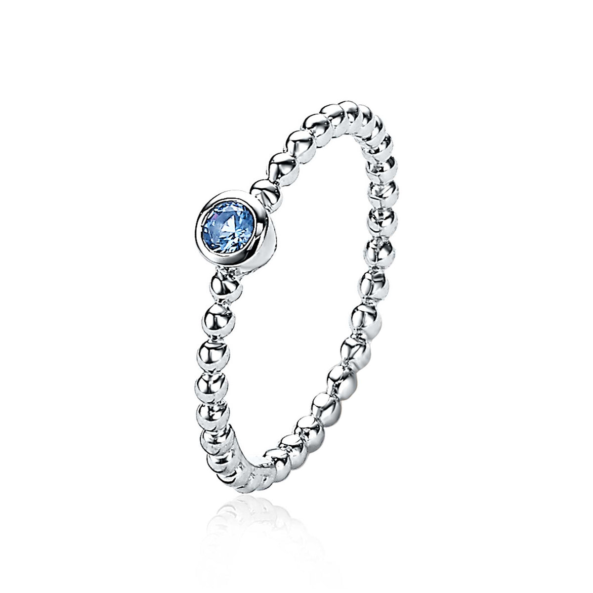 Bague en argent avec un motif de perles et un zircon bleu en serti.