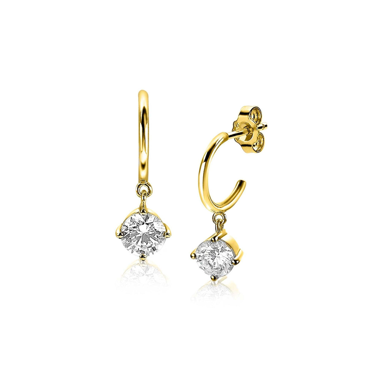 Boucles d'oreilles dorées avec pendentifs en forme de diamant transparent.