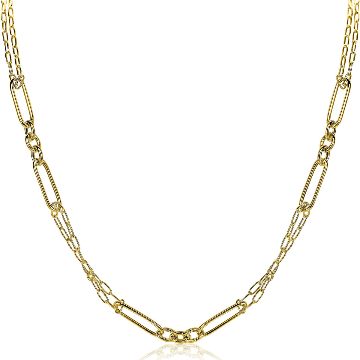 Collier doré avec des maillons allongés et des détails brillants.