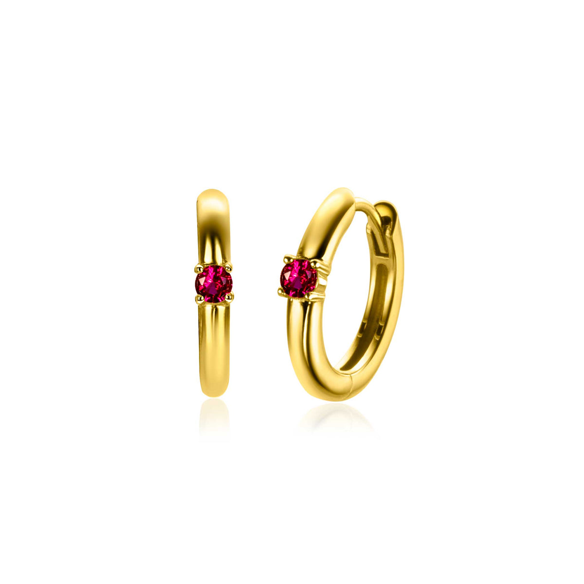 Boucles d'oreilles dorées avec un zircon rose au centre.