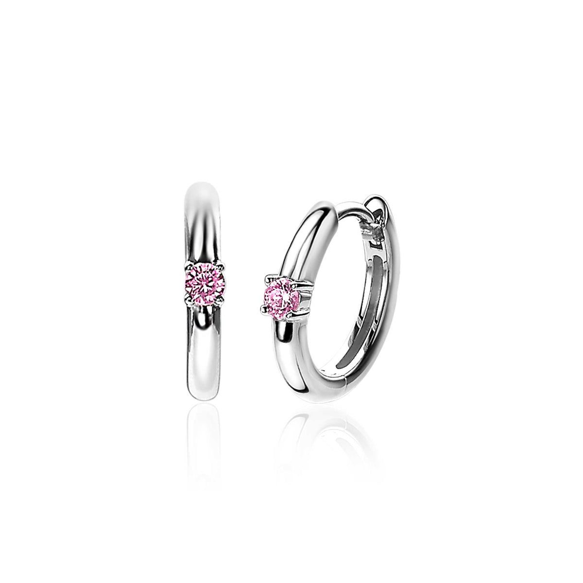 Boucles d'oreilles en argent avec un petit zircon rose au centre.