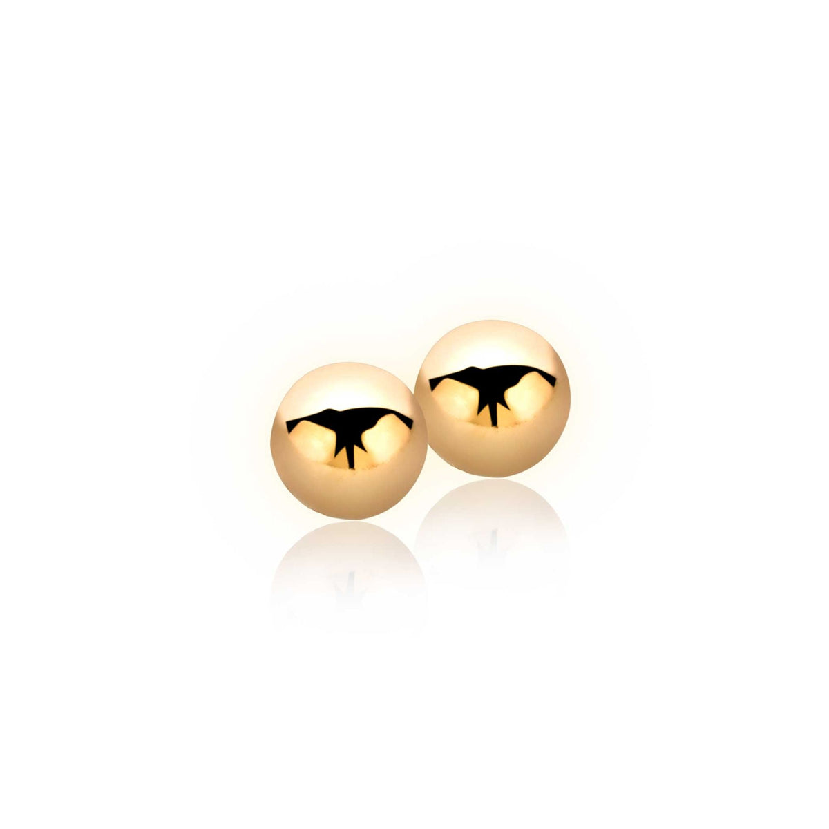 Boucles d'oreilles dorées en forme de sphères avec un motif découpé.