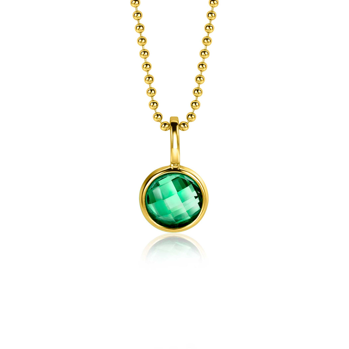 Pendentif doré avec une pierre verte facettée, suspendu à une chaîne à billes.