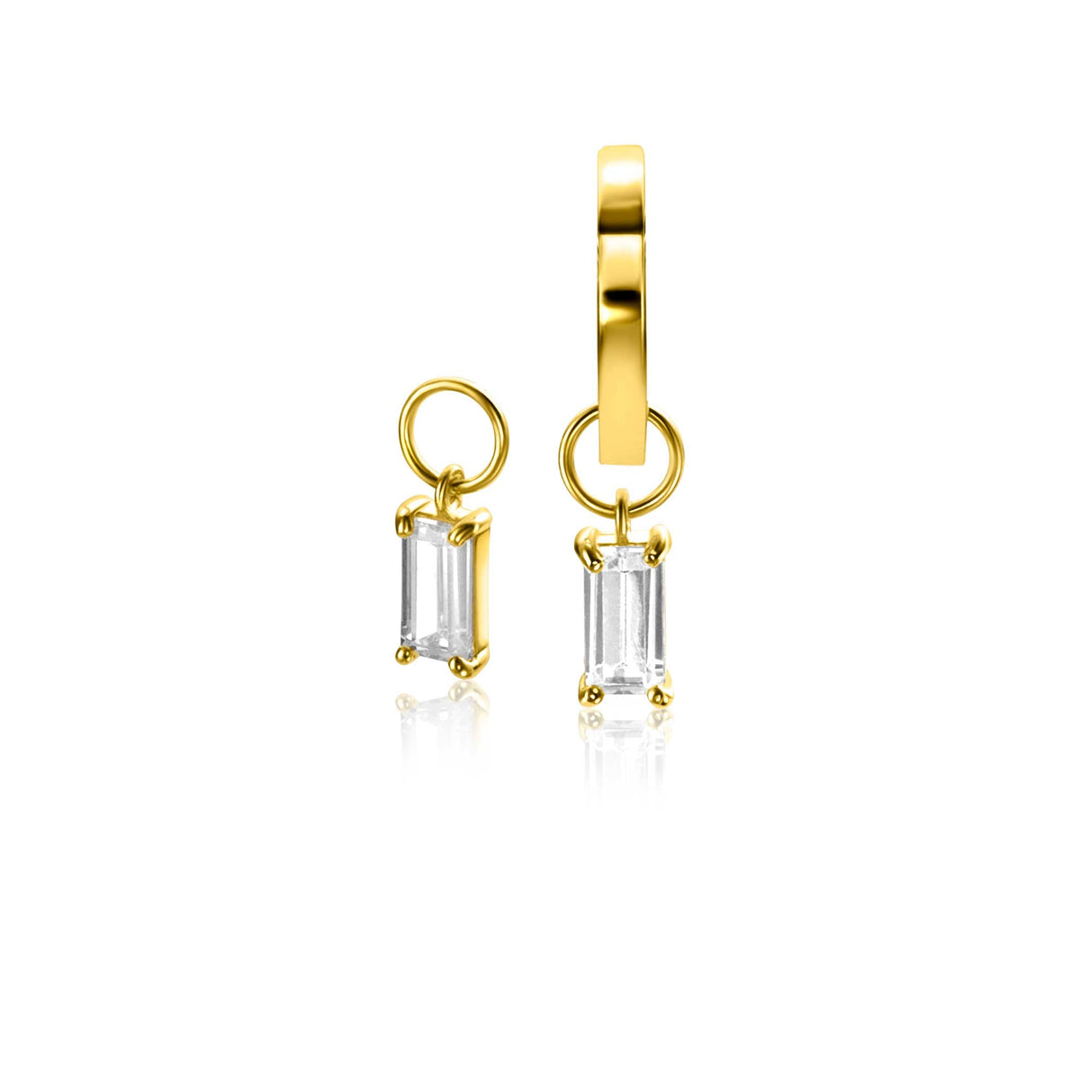 Boucles d'oreilles dorées avec un pendentif en cristal transparent en forme rectangulaire.
