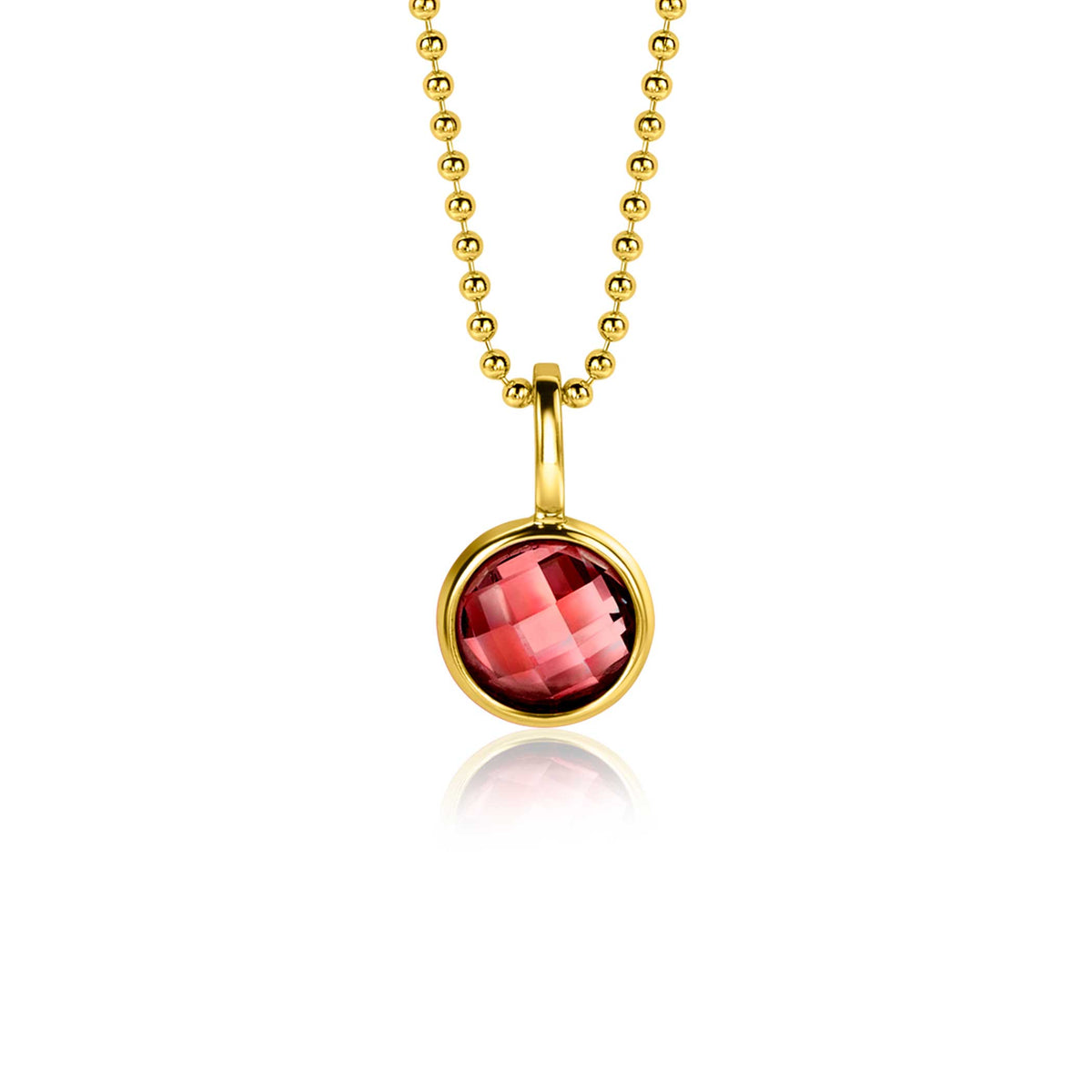 Pendentif doré avec une pierre rouge facettée, suspendu à une chaîne à billes.