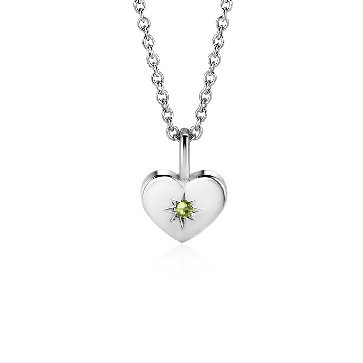 Pendentif en forme de cœur en argent avec une pierre précieuse verte.