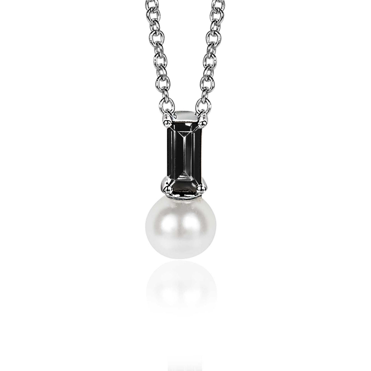 Pendentif en argent avec une perle blanche et une pierre noire en forme rectangulaire.