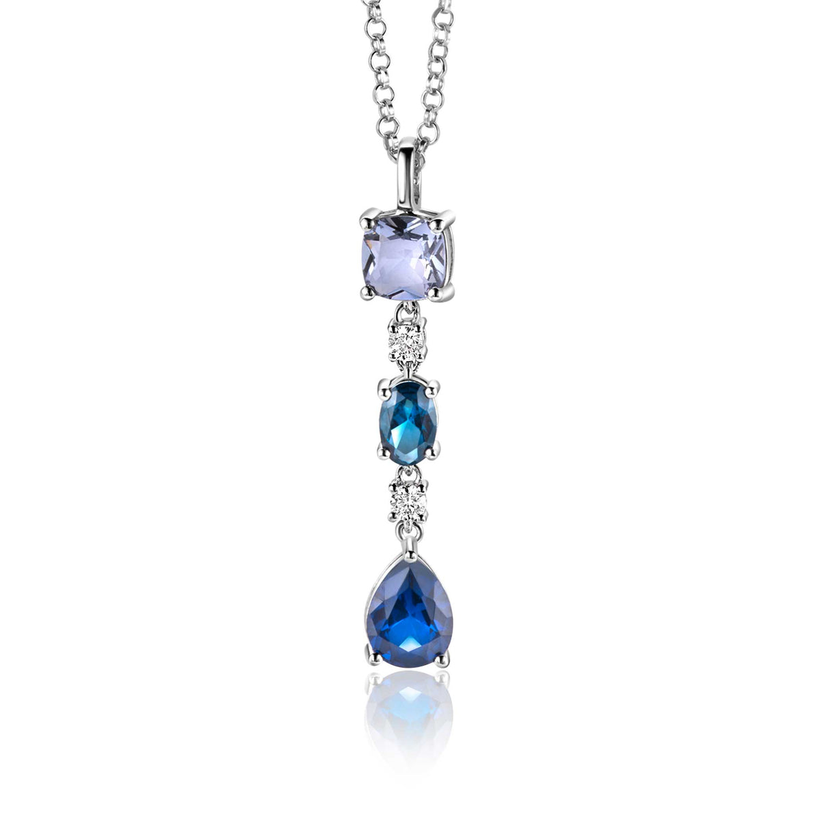 Pendentif en argent avec trois pierres précieuses, dont une en forme de poire, dans des tons de bleu.