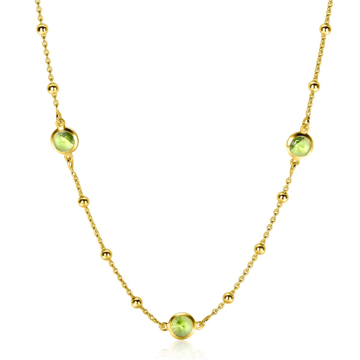 Collier doré avec des perles et des cabochons verts.