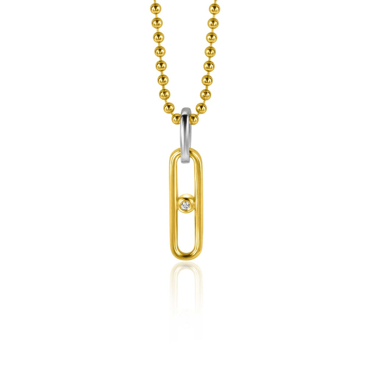 Pendentif doré en forme de trombone avec une petite pierre brillante, suspendu à une chaîne à billes.